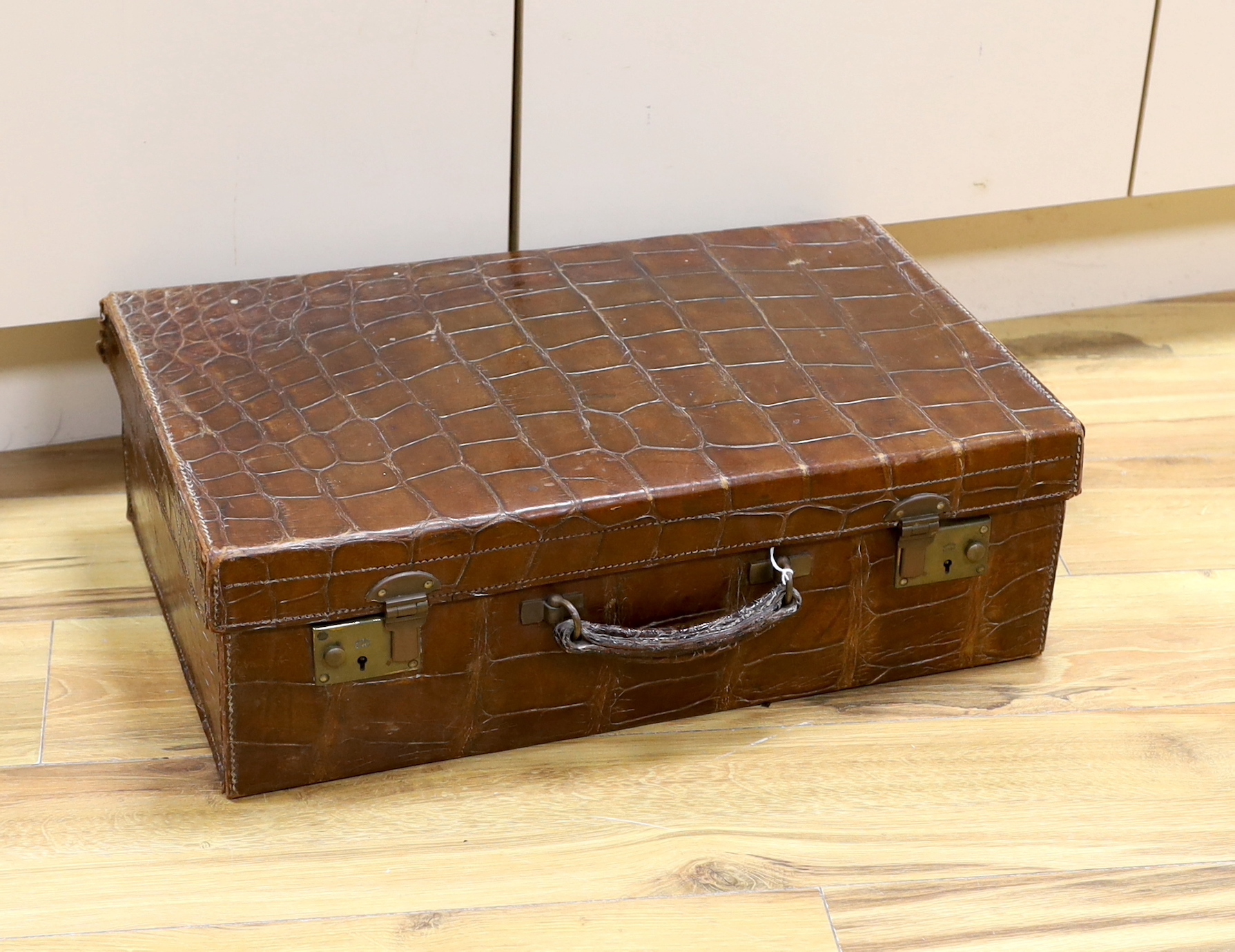 A Vintage 1930’s crocodile skin travelling case, 56cm wide